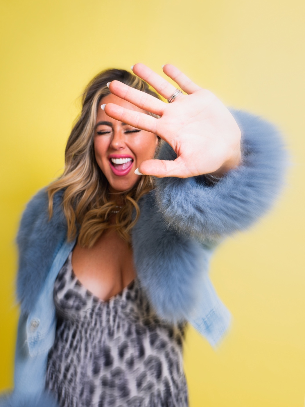 Ashleigh Malangone laughing in a blue fur jacket