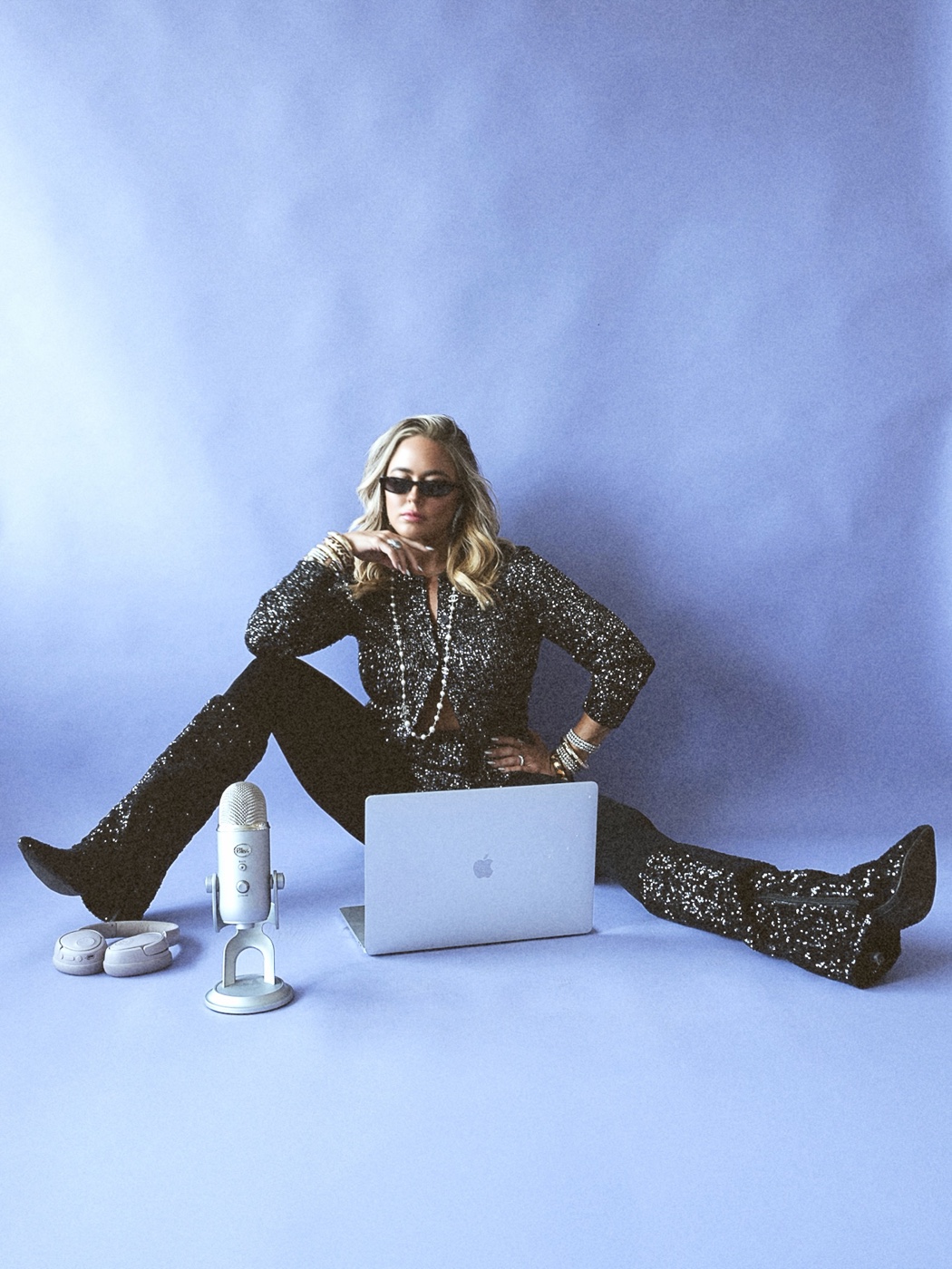 Ashleigh Malangone recording The Eternal Entrepreneur with a laptop and microphone