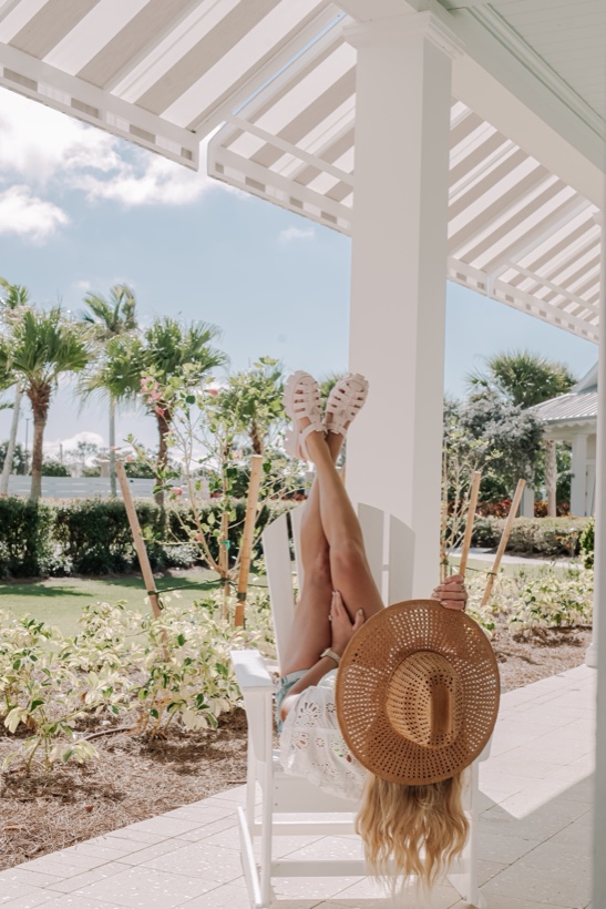 Ashleigh Malangone poolside among palm trees