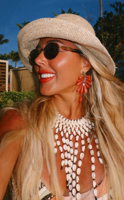 Ashleigh Malangone in a straw hat by the water