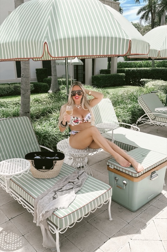 Ashleigh Malangone under a striped cabana